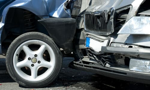 A closeup of multiple vehicles involved in a chain reaction car accident.