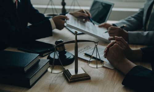 A gap insurance lawyer seated at a meeting with clients about their claim.