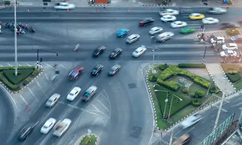 An aerial view of heavy traffic at a merge lane where vehicles are entering a main highway.