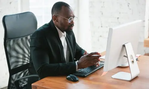 A police chase lawyer working at his computer and studying a client's car accident case.