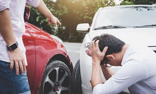 Drivers having a verbal exchange over fault after a collision between their vehicles during a turn.