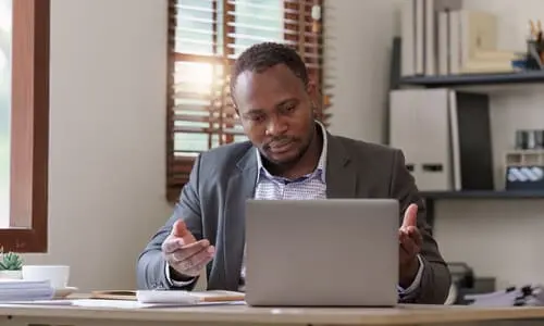 A lawyer in his office preparing for a client's improperly loaded cargo accident claim.