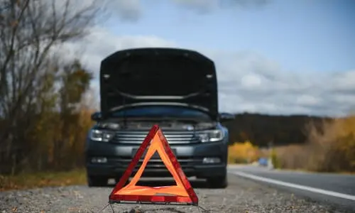 A vehicle stranded on a highway after getting into an accident caused by poor vehicle maintenance.