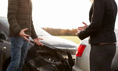 Two drivers caught in an argument after a collision caused by an unsafe lane change.