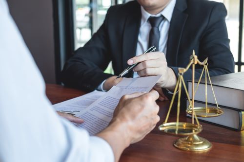 A car seat lawyer talking with a client about the details of their accident and injury case.