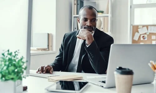 A lawyer glancing at his laptop screen thinking up a strategy for his client's claim.