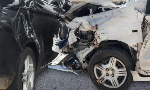A T-bone collision between a rideshare vehicle and another car on a city road.